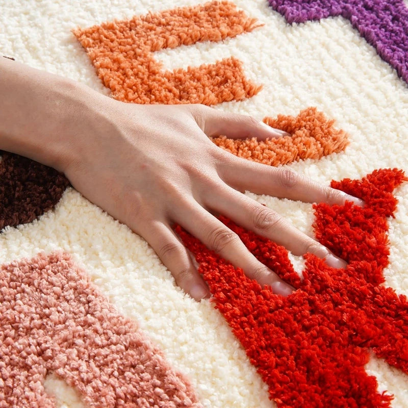 Hand touching a colorful textured surface with letters boho home decor, bathroom rug, tufted bath mat, Get Naked rug, colorful shower mat, apartment decor, dorm bathroom accessories, housewarming gift, microfiber bath mat, fun bathroom rug, American style bath mat