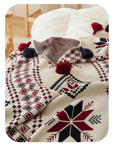 Decorative blanket with a geometric pattern on a bed