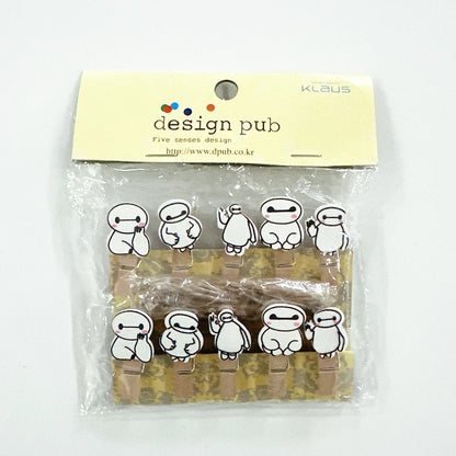 Packaged wooden clips with cartoon character designs on a white background, branded 'Klaus' and 'Design Pub'.