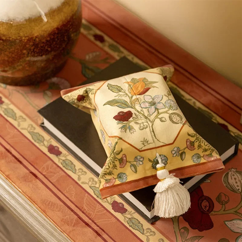 Decorative box with floral design and tassel on a patterned surface boho home decor, reusable tissue bag, cotton tassel tissue holder, plush tissue organizer, bathroom tissue box cover, car tissue case, American style tissue pouch, soft fabric tissue holder, decorative tissue box, housewarming gift, eco-friendly storage