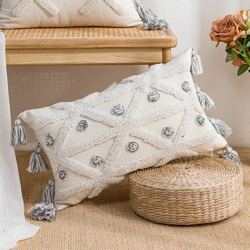 Decorative pillow with tassels on a woven stool with a neutral background Nordic blue tufted cushion cover with geometric stripe and grid crochet pattern, tassel pillow cover for sofa, bed, and boho home decor