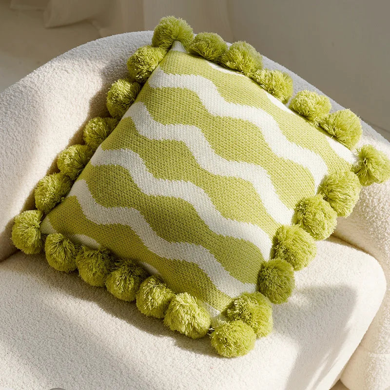 Green and white striped pillow with pom-pom trim on a white surface boho home decor, housewarming gift, embroidered pillow cover, flying bird cushion, animal pattern pillowcase, decorative throw pillow, Nordic cushion cover, luxury boho accent, sofa decor, nature-inspired pillow, canvas cushion case, textured home accessories