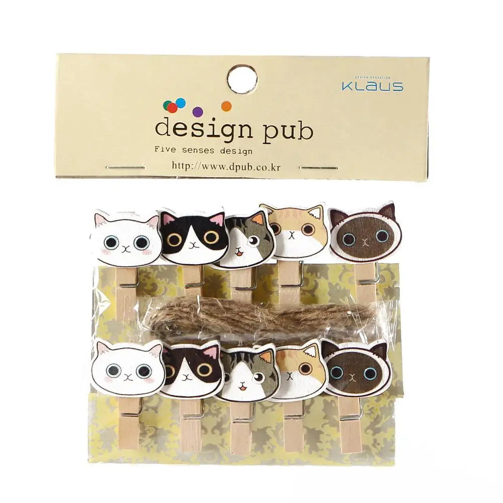 Packaged cat-themed paper clips with 'design pub' branding on a beige background