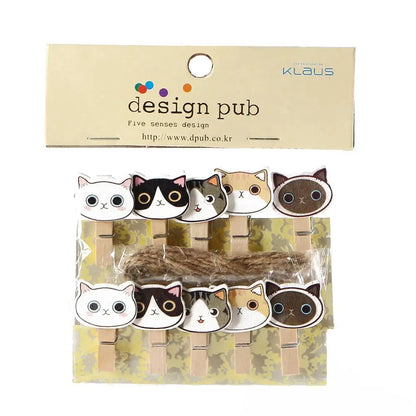 Packaged cat-themed paper clips with 'design pub' branding on a beige background