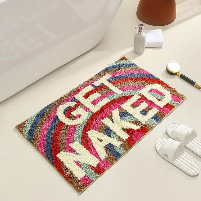 Colorful bath mat with 'GET NAKED' text on a bathroom floor. boho home decor, bathroom rug, tufted bath mat, Get Naked rug, colorful shower mat, apartment decor, dorm bathroom accessories, housewarming gift, microfiber bath mat, fun bathroom rug, American style bath mat