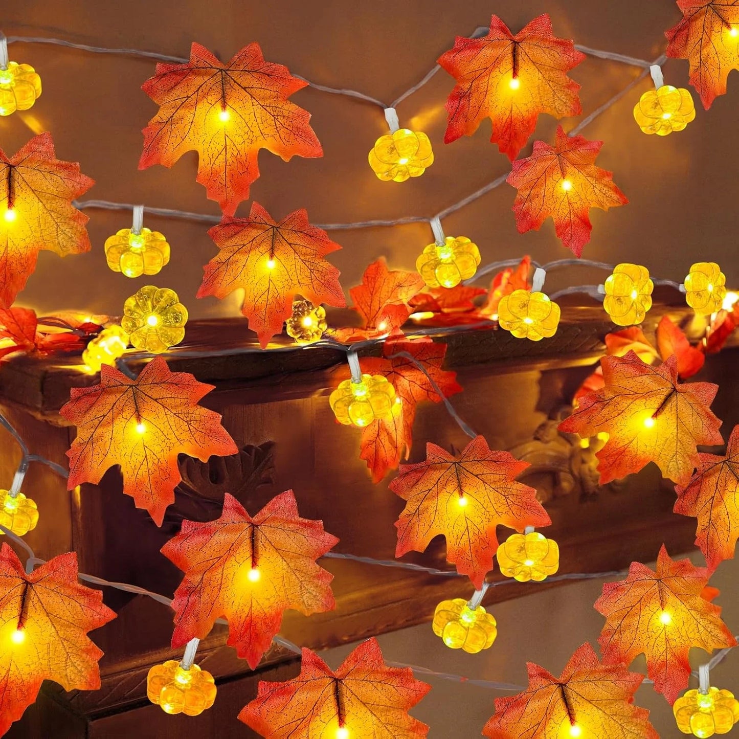 String lights with autumn leaf and pumpkin decorations on a wooden surface. fall leaf lights 