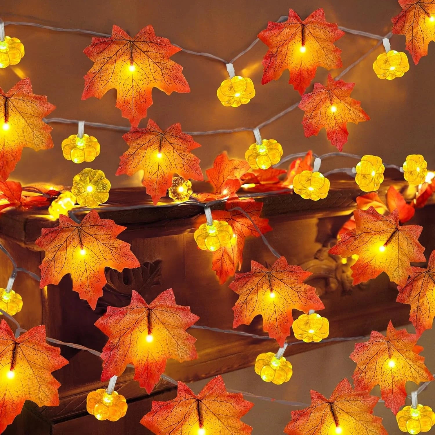 String lights with autumn leaf and pumpkin decorations on a wooden surface. fall leaf lights 