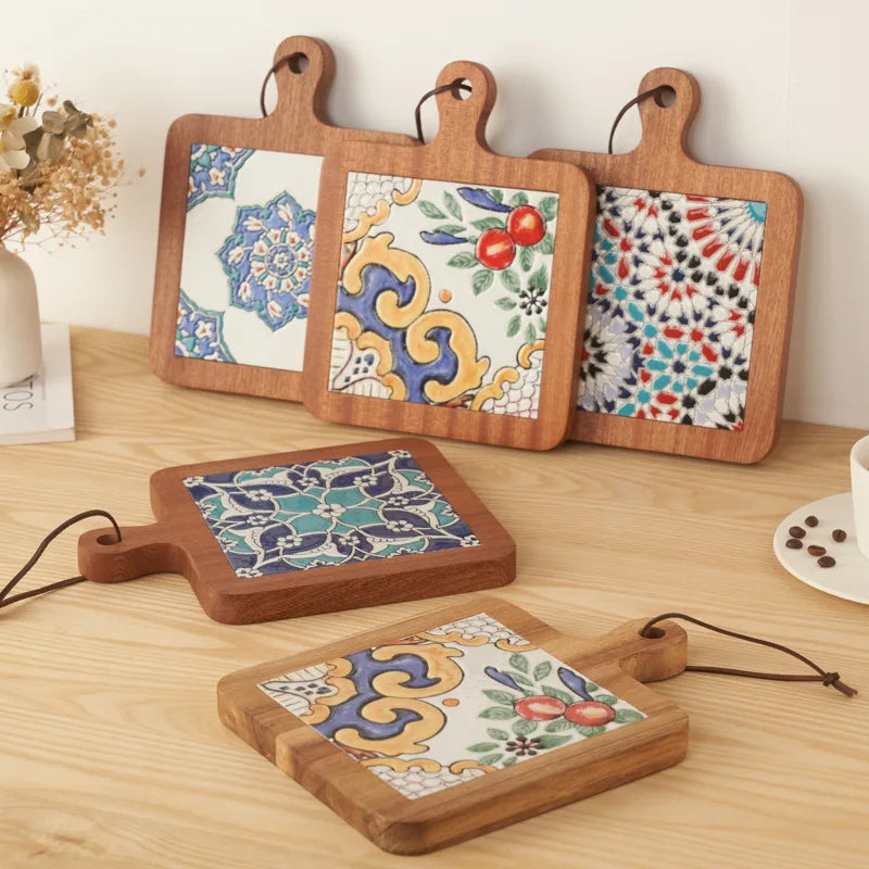 Set of wooden coasters with colorful tile designs on a wooden surface.
