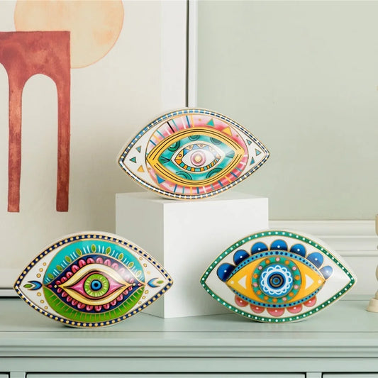 Three Moroccan Turkish blue evil eye ceramic figurines on display, unique bohemian home decor accent perfect for eclectic and boho home styles, adds soulful vibes and a cozy touch to any room, great for gifting as a boho home decor gift or housewarming present