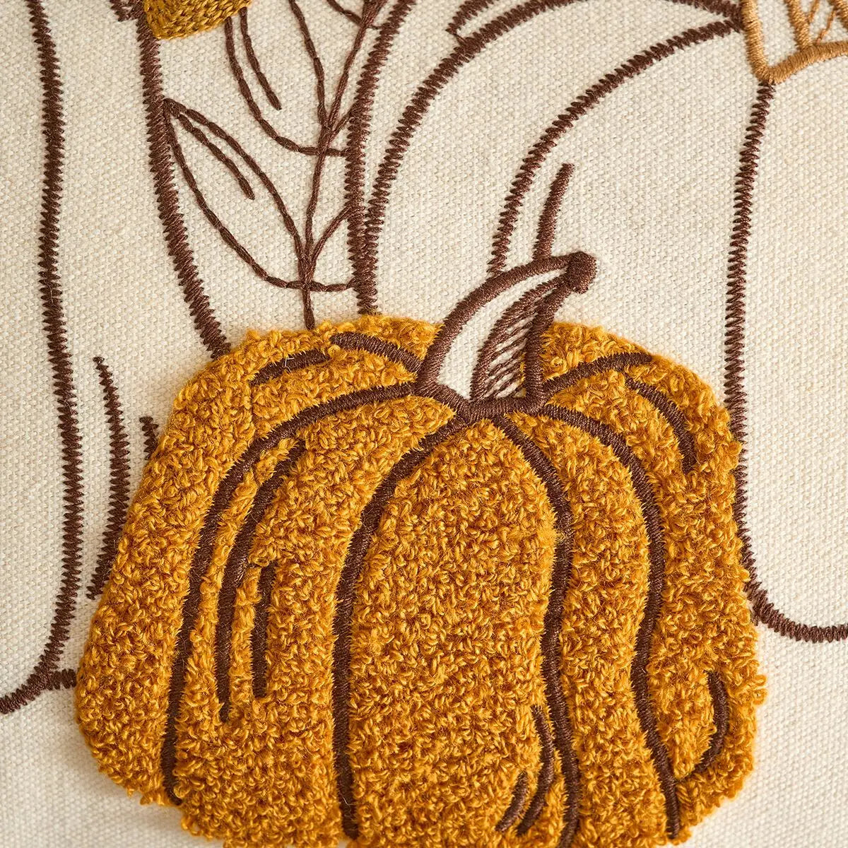 Embroidered pumpkin design on a fabric background. Festive autumn pumpkin cushion case for sofa or bed