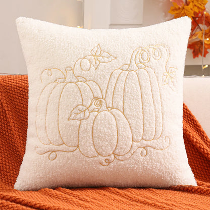 Decorative pillow with embroidered pumpkins on an orange surface. fall boho pillow throw gift ideas