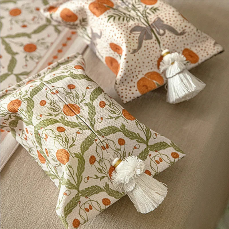 Decorative pillows with floral patterns and tassels on a neutral surface boho home decor, reusable tissue bag, cotton tassel tissue holder, plush tissue organizer, bathroom tissue box cover, car tissue case, American style tissue pouch, soft fabric tissue holder, decorative tissue box, housewarming gift, eco-friendly storage