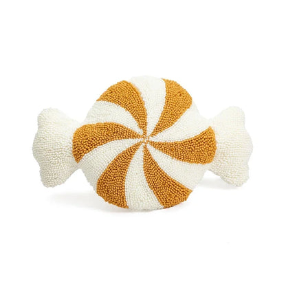 Decorative candy-shaped pillow with orange and white swirl pattern on a white background