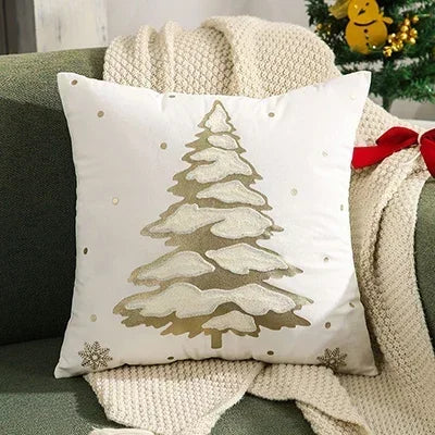 Decorative pillow with a Christmas tree design on a couch. Embroidered Merry Christmas pillow cover with snowflake design – festive red and white holiday cushion for sofa or bedroom décor.