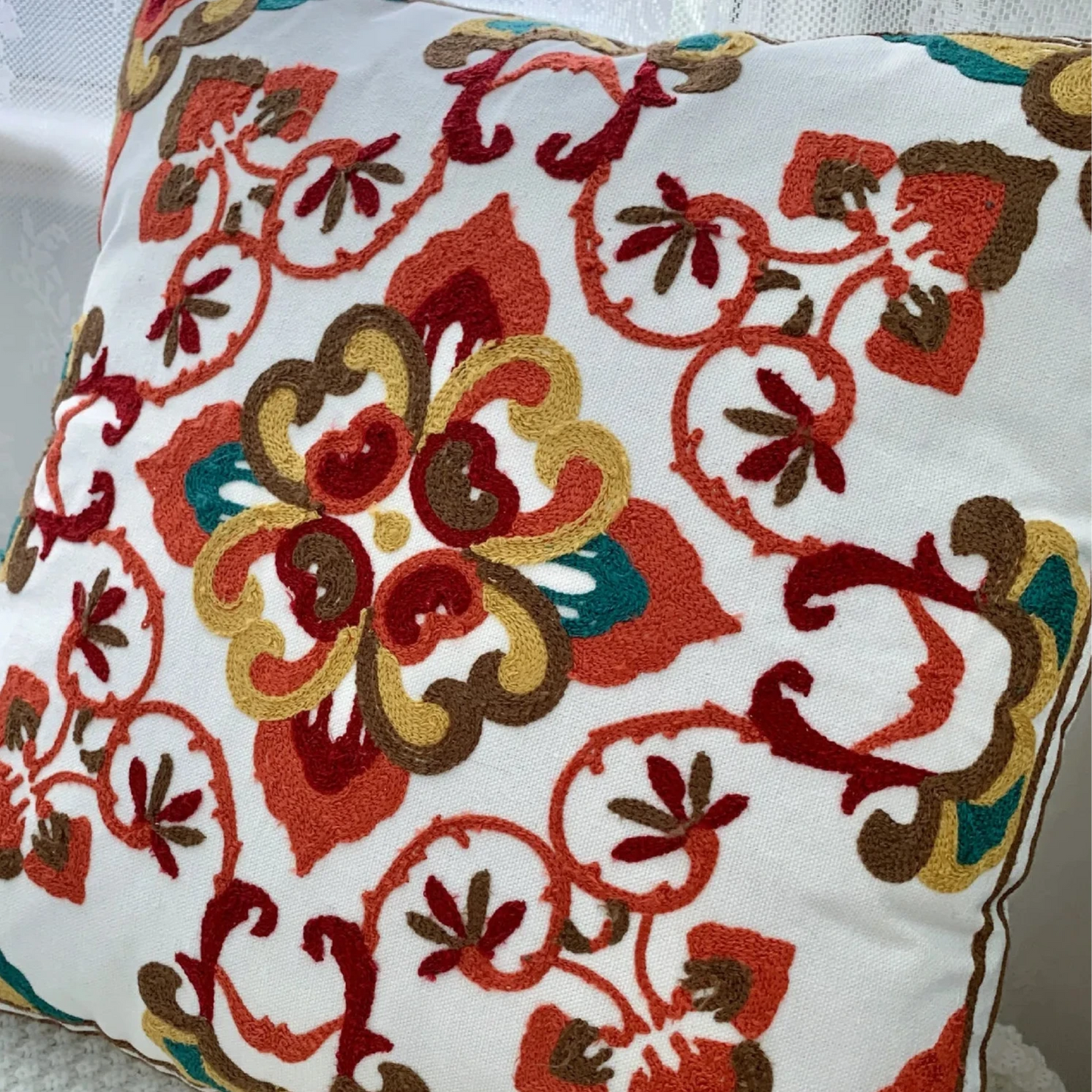 Decorative pillow with floral pattern on a white surface, floral embroidery on linen cotton cushion cover – boho home decor accent