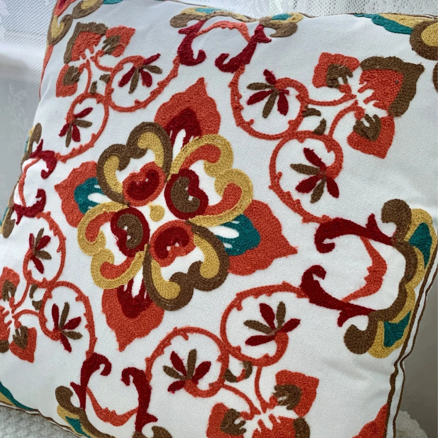 Decorative pillow with floral pattern on a white surface, floral embroidery on linen cotton cushion cover – boho home decor accent