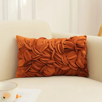 Orange decorative pillow on a beige sofa with a neutral background. Handmade patchwork floral pillowcase for bed or living room