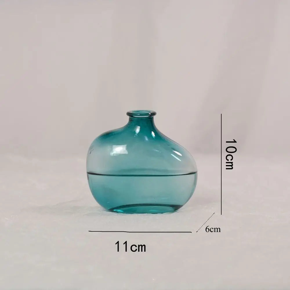 Teal glass vase with dimensions on a light gray background