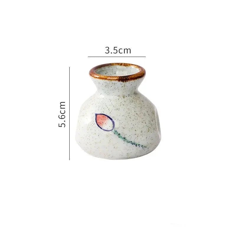Small ceramic vase with measurements on a white background