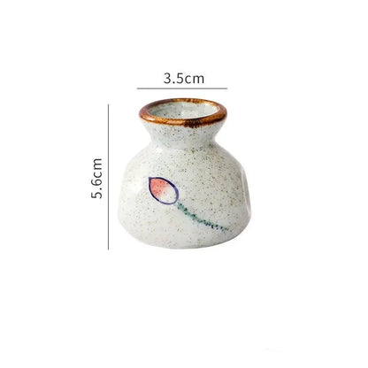 Small ceramic vase with measurements on a white background