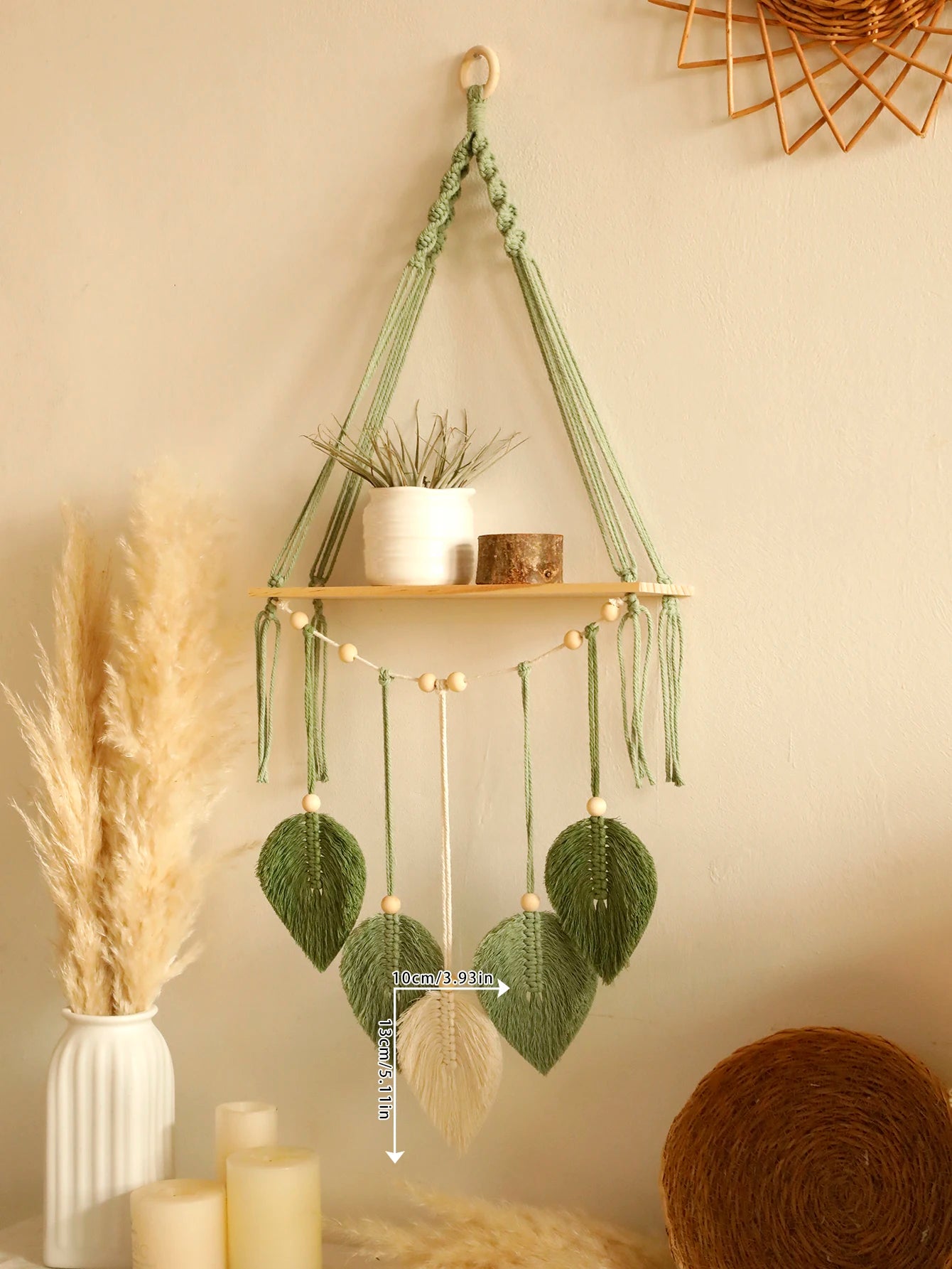 Decorative wall hanging with plants and lights on a neutral background