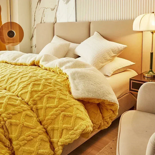 Bedroom with a bed covered in yellow and white bedding, pillows, and a lamp on a nightstand. Soft plush duvet cover and blanket in solid color with striped jacquard design, dual-use artificial cashmere fleece bedding for cozy winter warmth