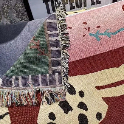Close-up of a patterned fabric with fringe on a textured surface Leopard design boho home decor blanket, decorative woven tapestry for living room or bedroom