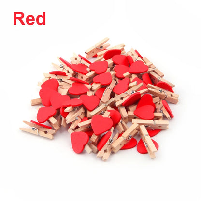 Red heart-shaped wooden clips on a white background