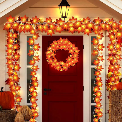 Decorative autumn garland with lights around a red door. fall leaf lights 