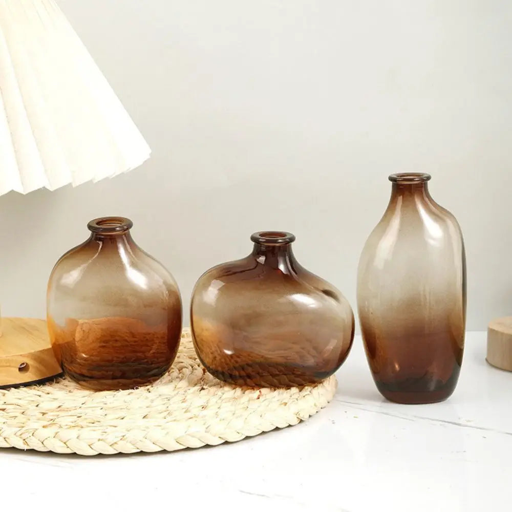 Three brown gradient vases on a textured surface with a white background. Boho Home Decor. 