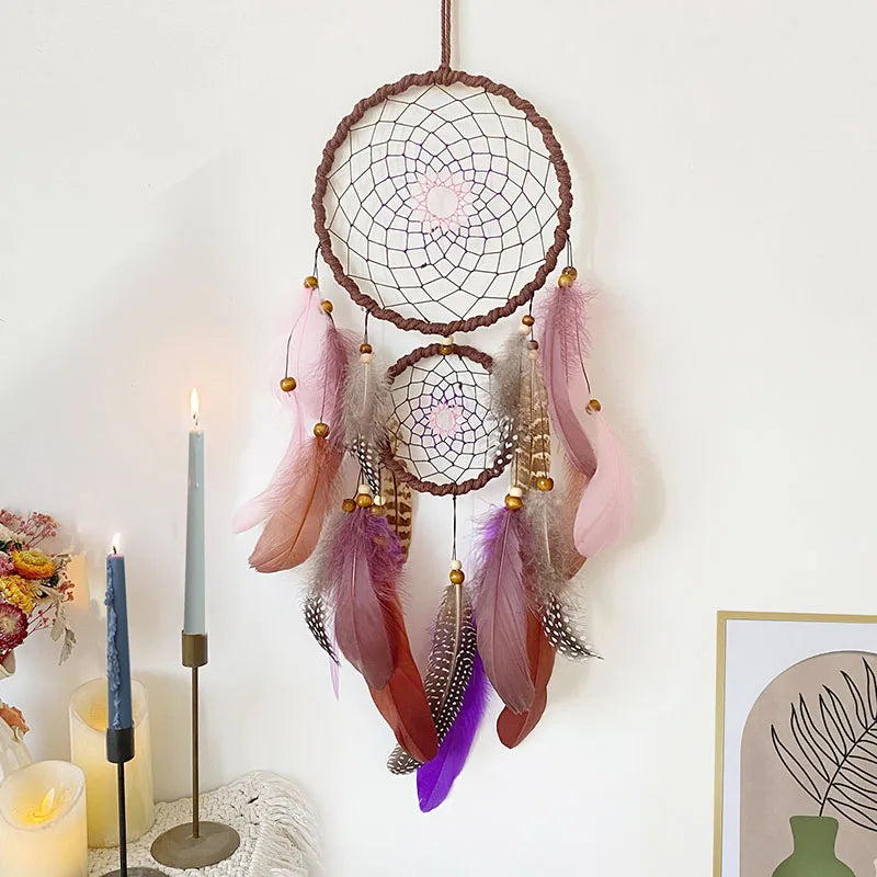Dreamcatcher with feathers hanging on a white wall with candles and decor. boho home decor, housewarming gift, dream catcher wall hanging, feather wind chime, handmade dreamcatcher, colorful boho wall decor, birthday gift decor, modern bohemian style, bedroom hanging ornament, spiritual home decor, dreamcatcher nursery decor
