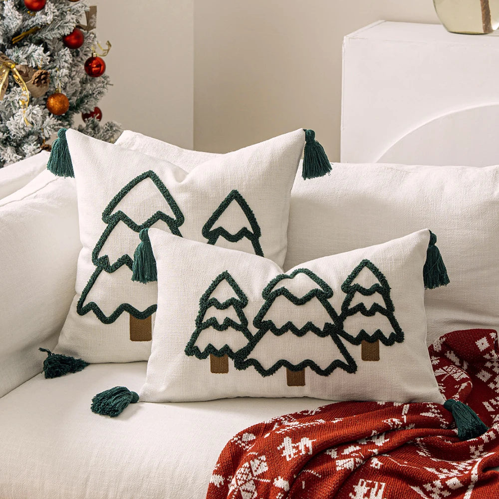 Decorative pillows with Christmas tree patterns on a couch next to a Christmas tree. tufted Christmas pillow cover with tassels, decorative festive cushion case for sofa or bed in 12x20 or 18x18 inches.