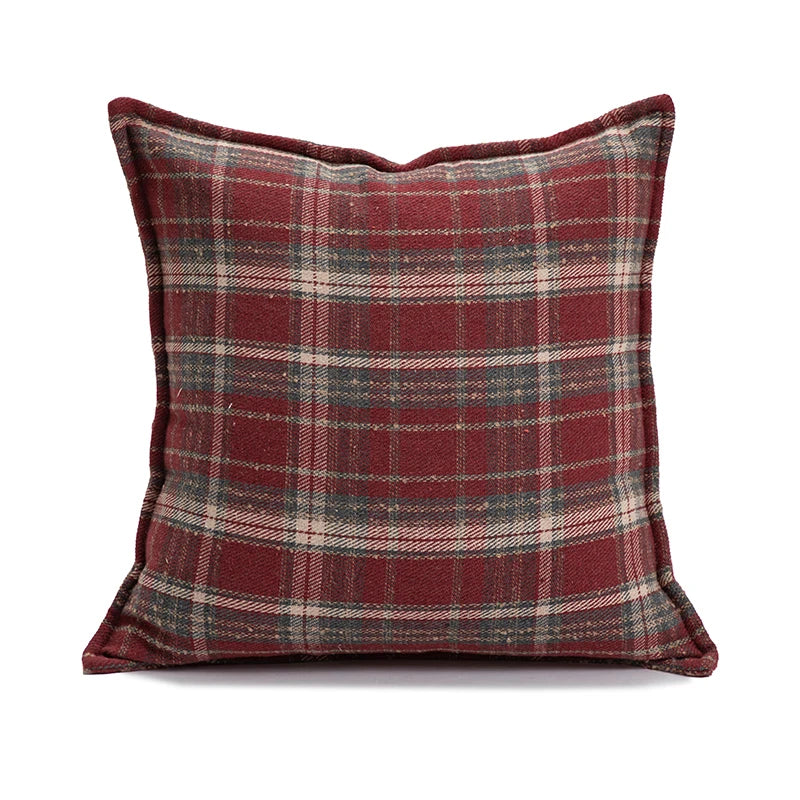 Plaid pillow with red and gray pattern on a white background