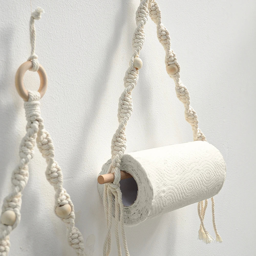 Macrame plant hanger with wooden rings and beads on a white background boho home decor, toilet paper holder, bohemian bathroom accessory, tissue holder, wall-mounted towel rack, cotton rope toilet paper rack, wooden bead towel holder, rustic home decor, boho wall decor, bathroom organization, housewarming gift