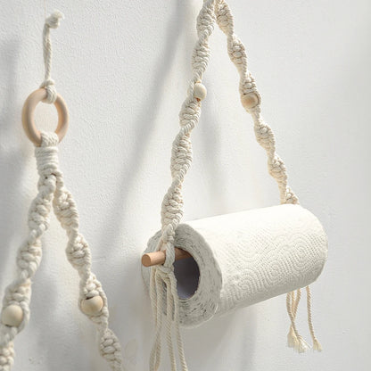 Macrame plant hanger with wooden rings and beads on a white background boho home decor, toilet paper holder, bohemian bathroom accessory, tissue holder, wall-mounted towel rack, cotton rope toilet paper rack, wooden bead towel holder, rustic home decor, boho wall decor, bathroom organization, housewarming gift