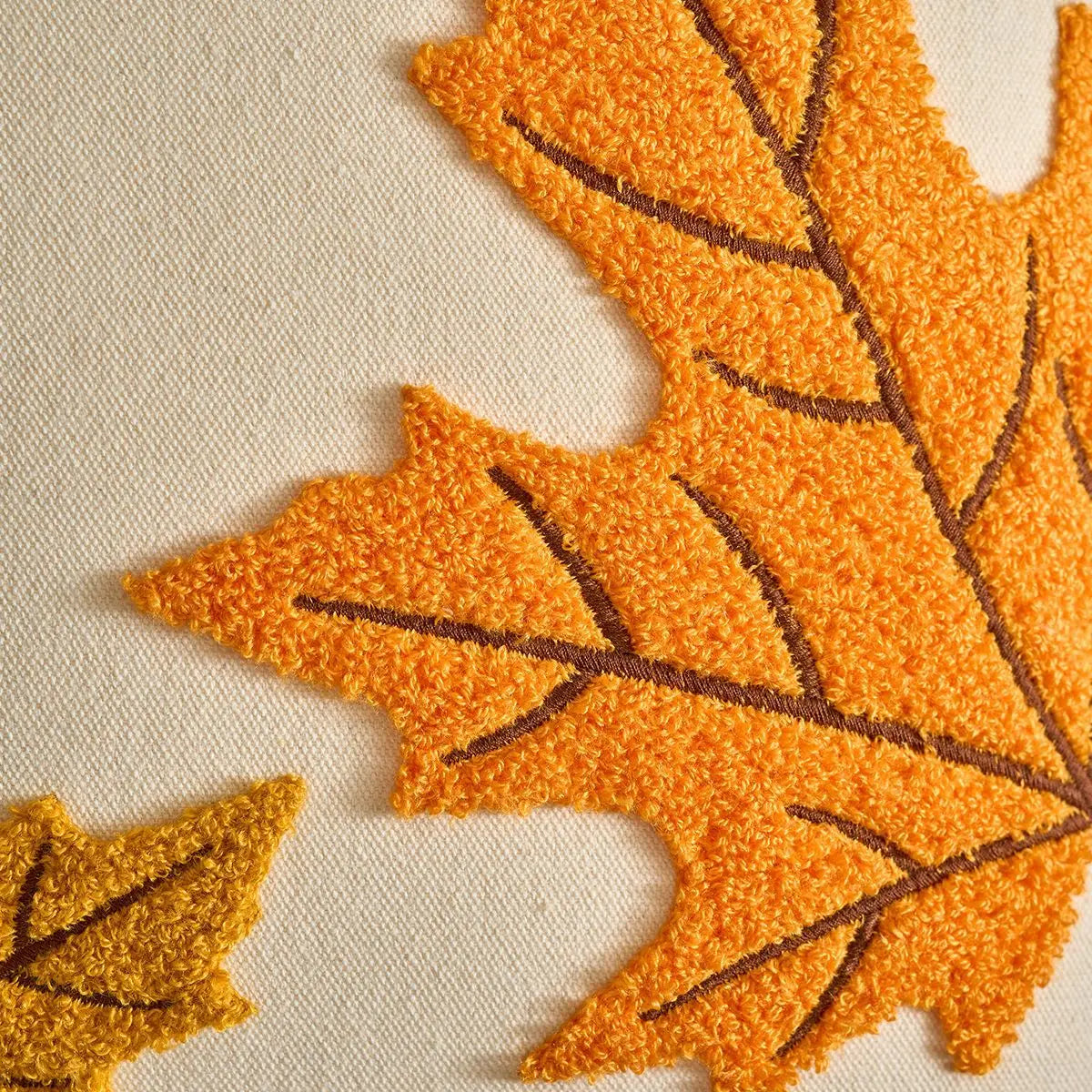 Close-up of textured orange leaves on a beige background. Halloween and Thanksgiving decorative pillow cover For Fall