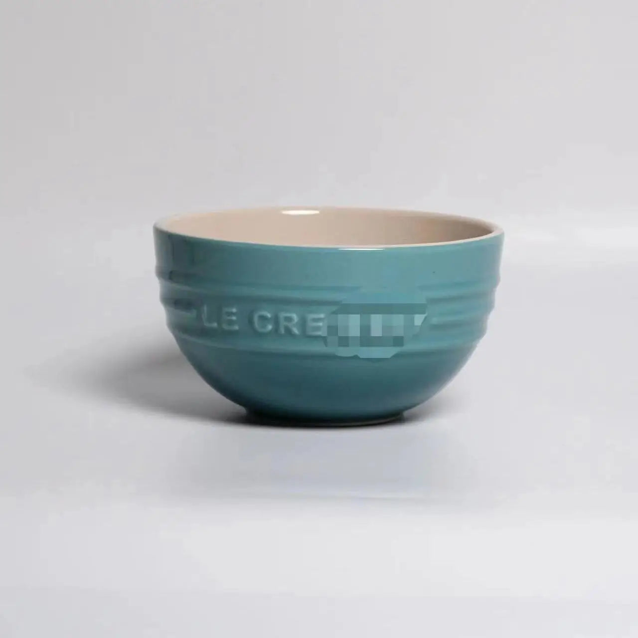 Teal mixing bowl with beige interior on a light gray background Gradient ceramic rice bowl in bright colors, bone china soup and noodle bowl, dessert and pudding kitchen tableware for boho home dining