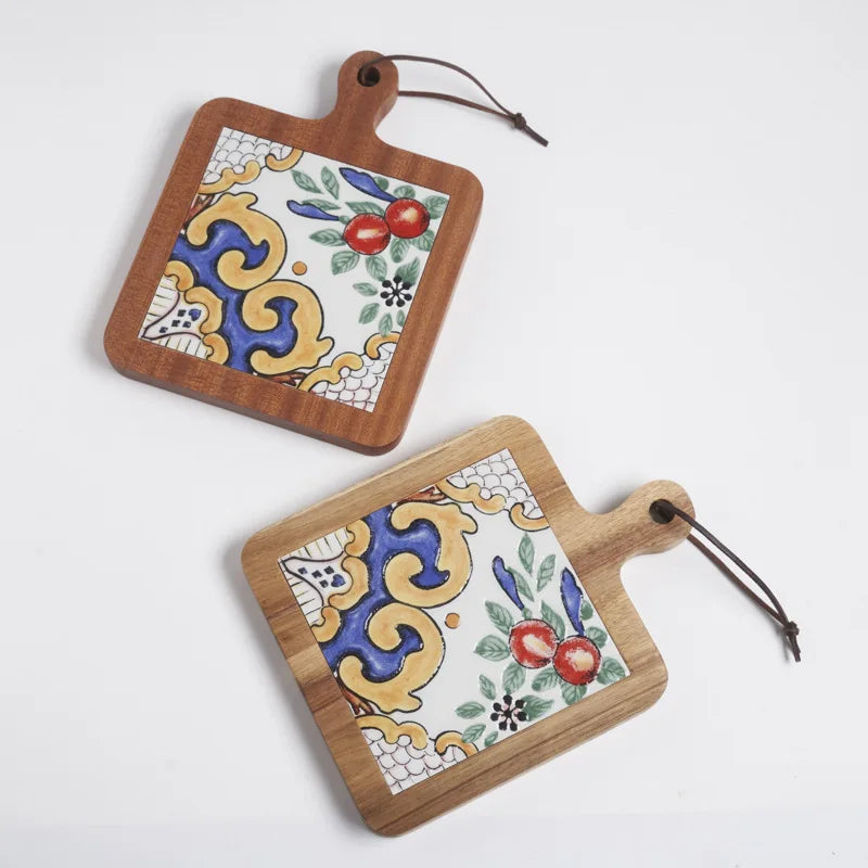 Two wooden cutting boards with decorative tile patterns on a white background