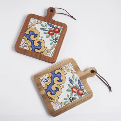 Two wooden cutting boards with decorative tile patterns on a white background