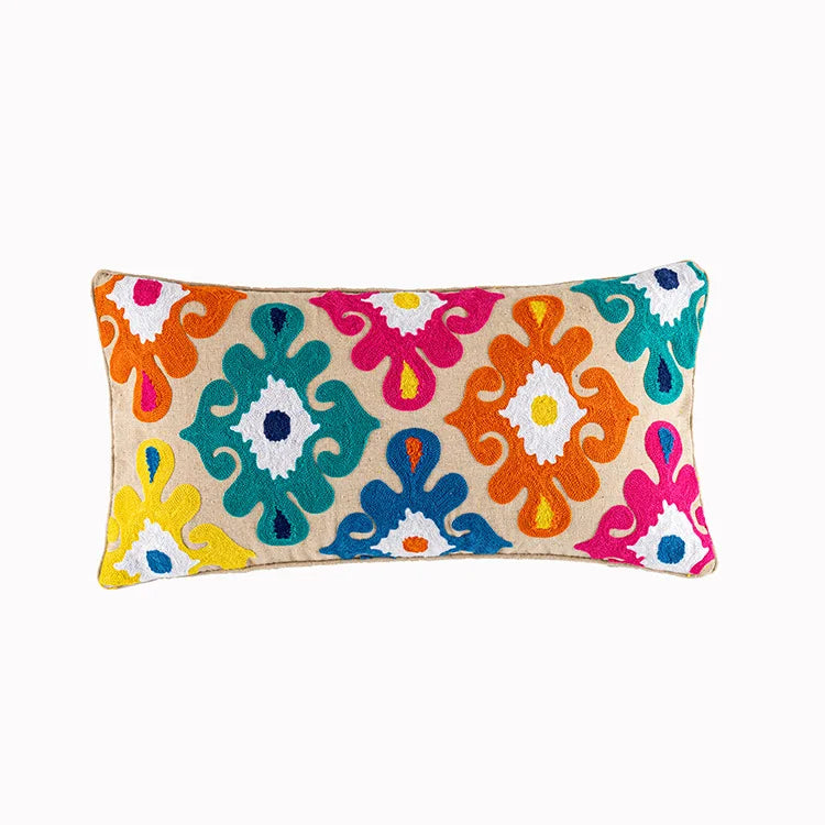 Colorful floral patterned pillow on a white background. Bohemian embroidered throw pillow cover with geometric design, cotton-blend cushion for sofa, bed, or modern home decor.