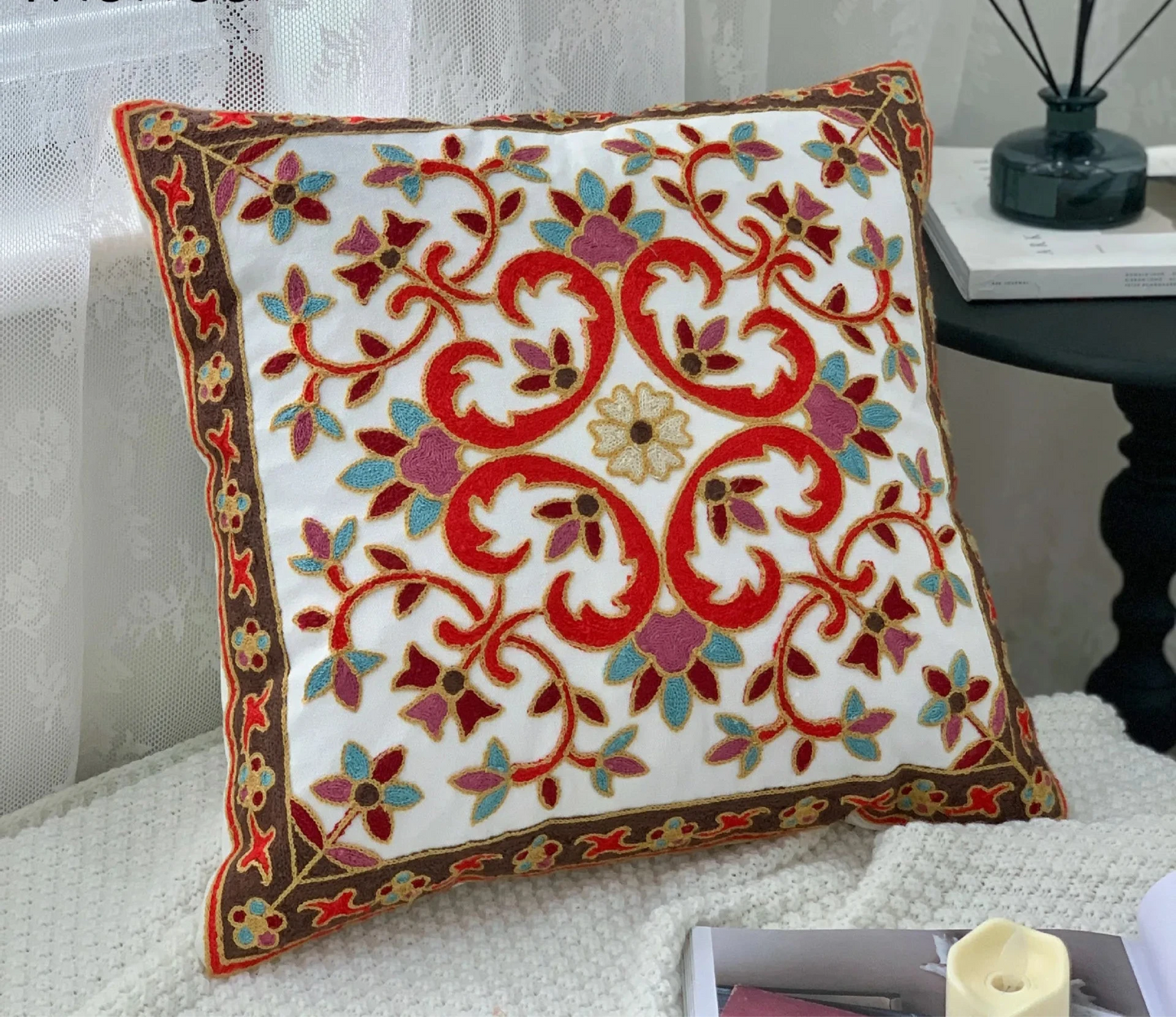 Decorative pillow with intricate patterns on a couch, floral embroidery on linen cotton cushion cover – boho home decor accent
