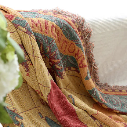 Colorful patterned blanket draped over a white surface. Bohemian world map woven blanket cotton sofa throw home decor