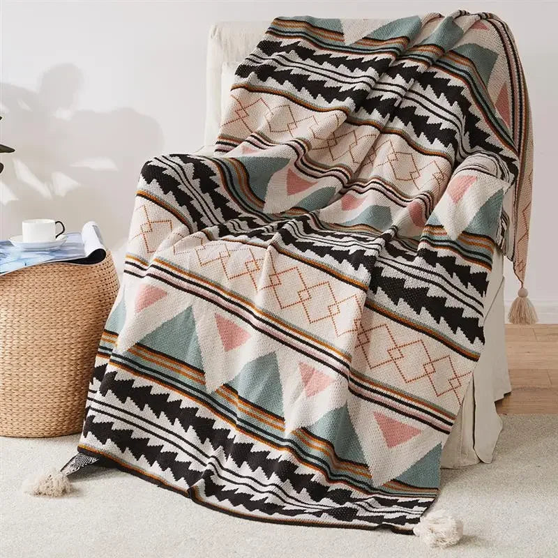 Bohemian Patterned blanket draped over a chair in a room with a woven basket.