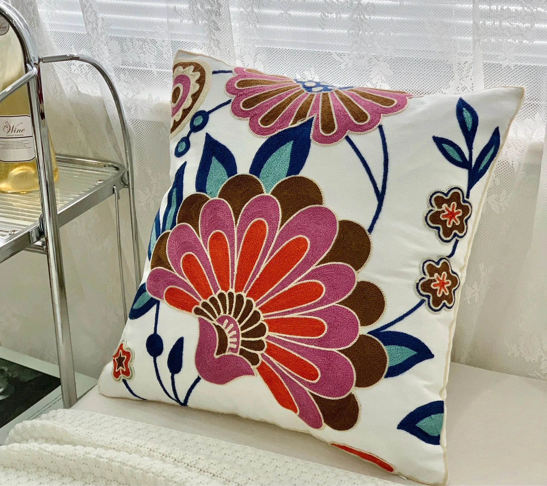 Decorative pillow with floral pattern on a couch, floral embroidery on linen cotton cushion cover – boho home decor accent