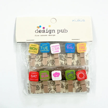 Packaged wooden clothespins with colorful labels on a white background, branded 'Design Pub'.