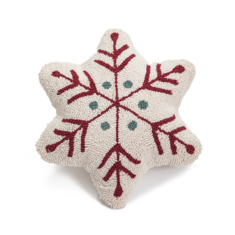 Decorative snowflake pillow with red and green patterns on a white background