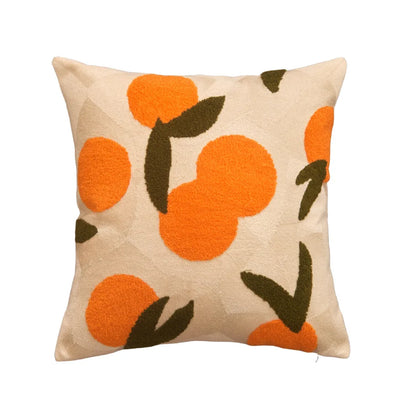 Decorative pillow with orange and green pattern on beige background