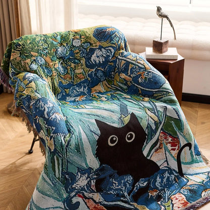 Decorative blanket with a cat design draped over a chair in a room. Cat woven throw blanket for boho sofa and home decor