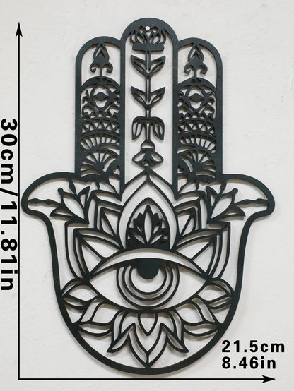 Black hamsa hand-shaped wood wall decor with protective evil eye, photographed against neutral background for alternative boho room styling.