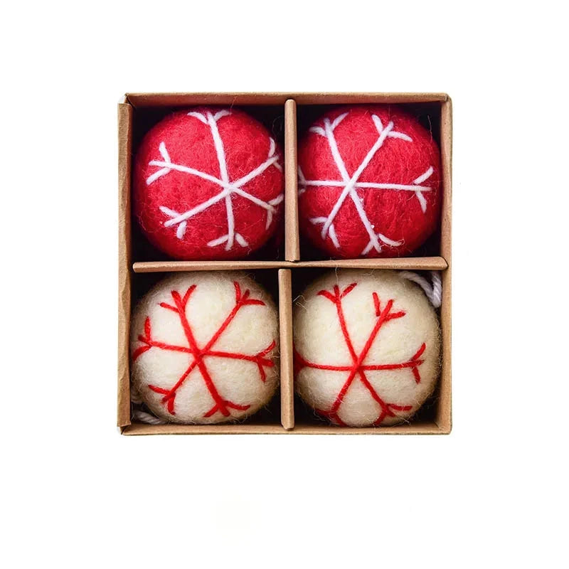 Four red and white textured Christmas balls in a box 